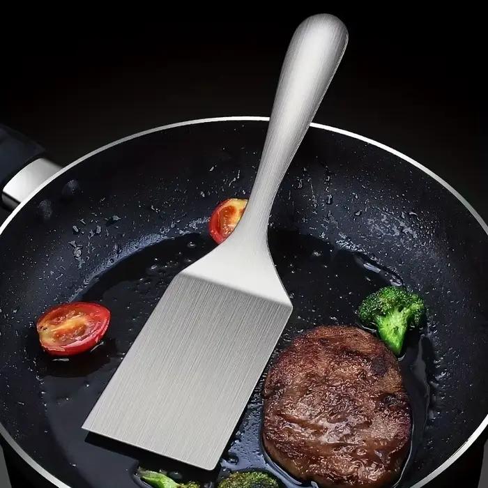 Spatule en acier inoxydable gris clair pour griller frire et cuisiner retourner des hamburgers steaks et crêpes poignée confortable et design ergonomique pour une utilisation facile et sûre